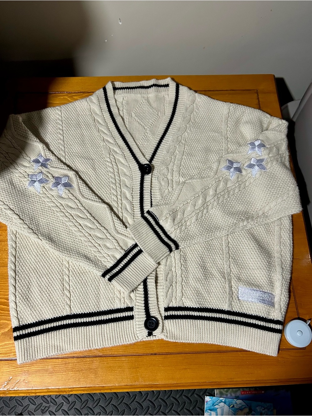 Taylor Swift Cream Cable-Knit Cardigan with Black Trim and Star Embroidery